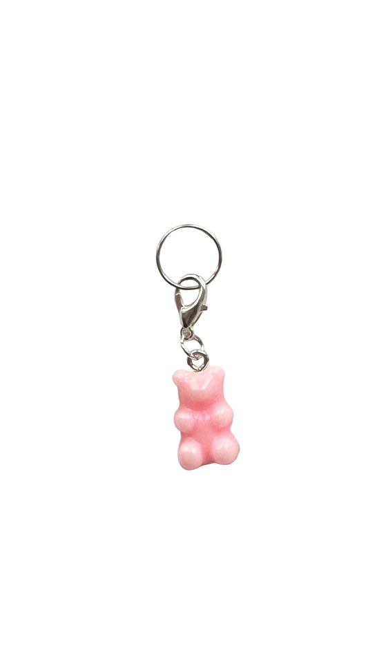 Pink gummy bear charm on a white background