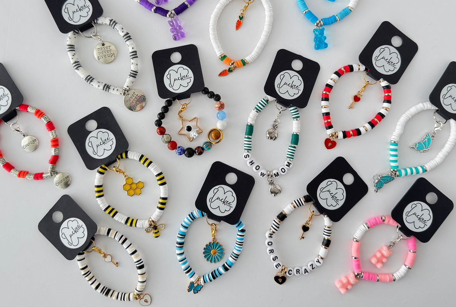 Set of bracelets on black cards with visible brand name on a light gray background.