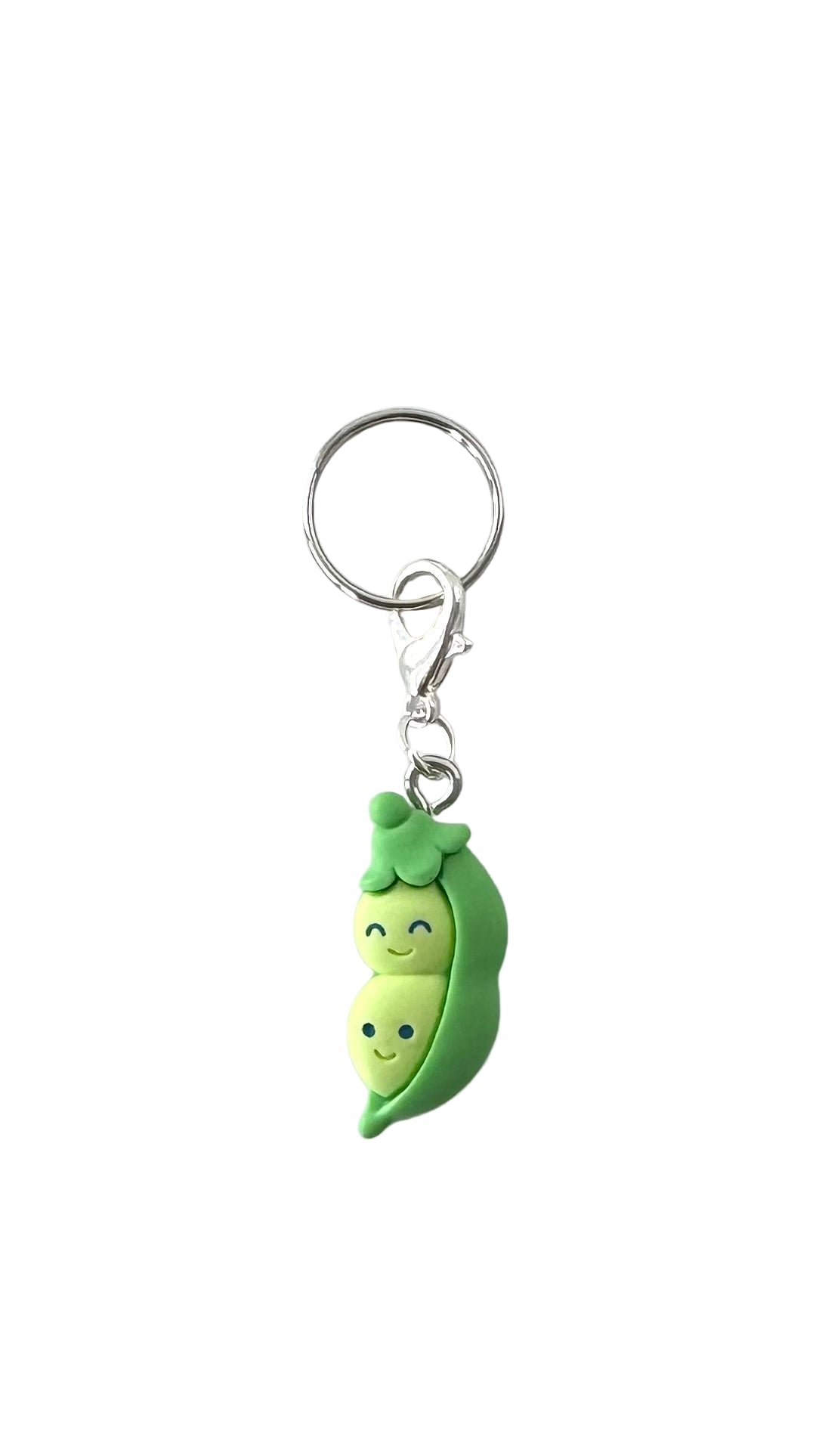 Keychain with a cute green pea pod design on a white background