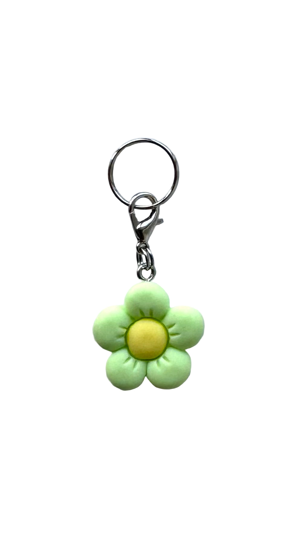 Flower-shaped charm with a yellow center on a white background