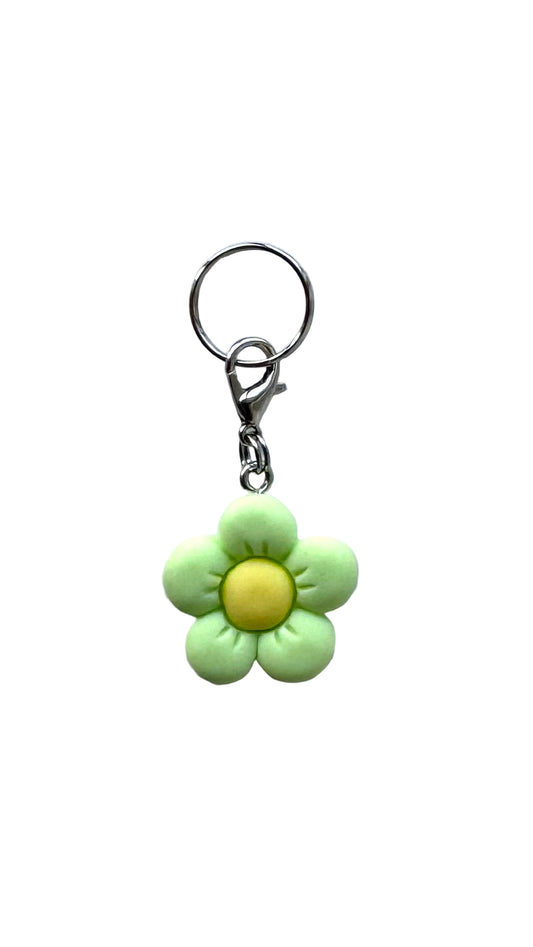 Flower-shaped charm with a yellow center on a white background