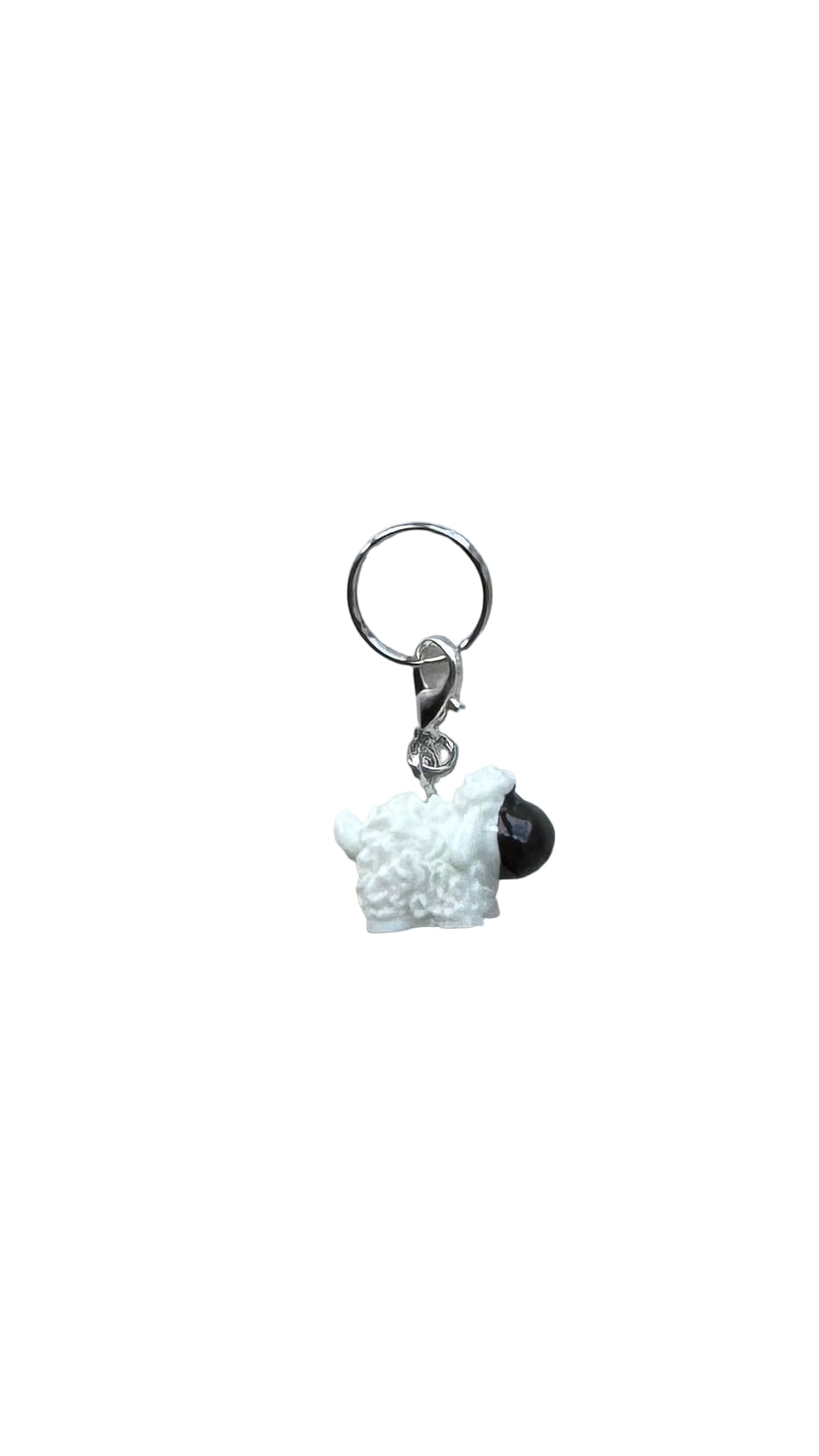 Small charm with a white sheep charm and black head on a white background