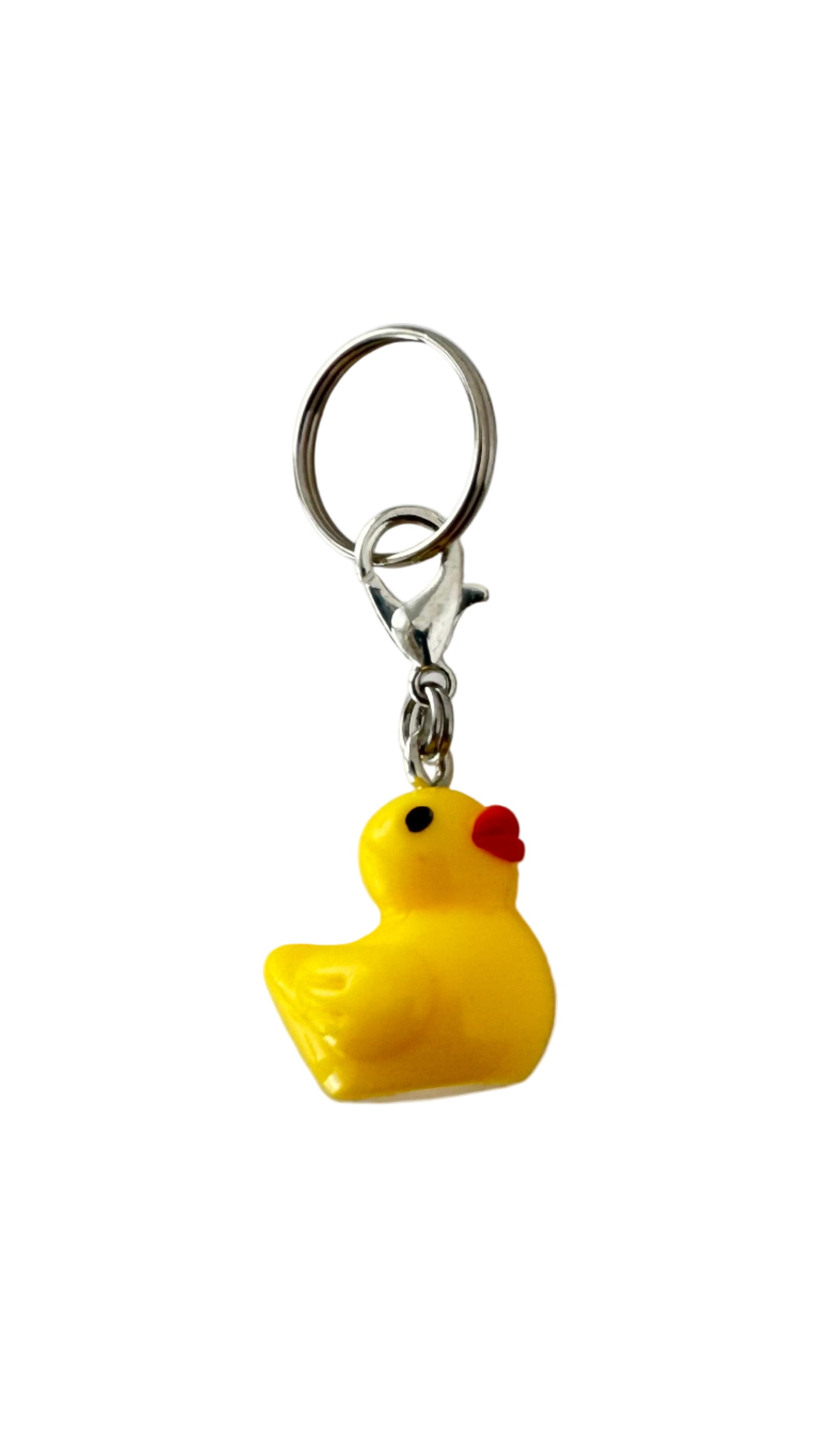 Yellow rubber duck charm on a white background.