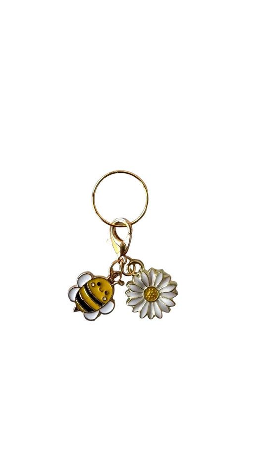 Charm with bee and daisy charm on a white background