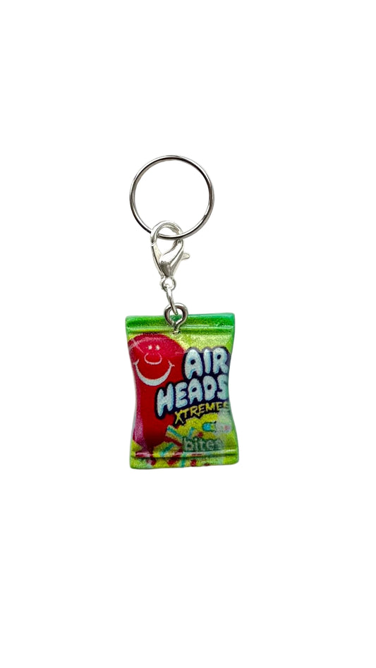 Charm shaped like a small package of Airheads Xtreme candy on a white background