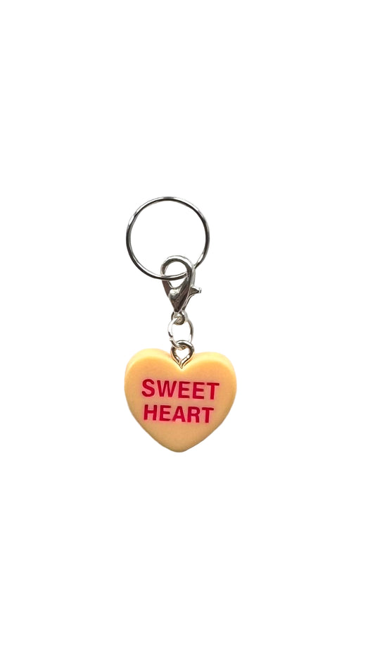 Heart-shaped charm with 'SWEET HEART' text on a white background