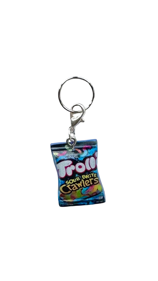 Charm shaped like a miniature package of Trolli Sour Brite Crawlers on a white background