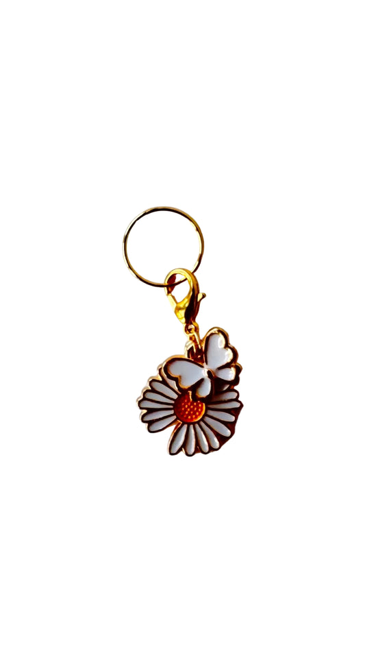 Charm with a flower and butterfly design on a white background