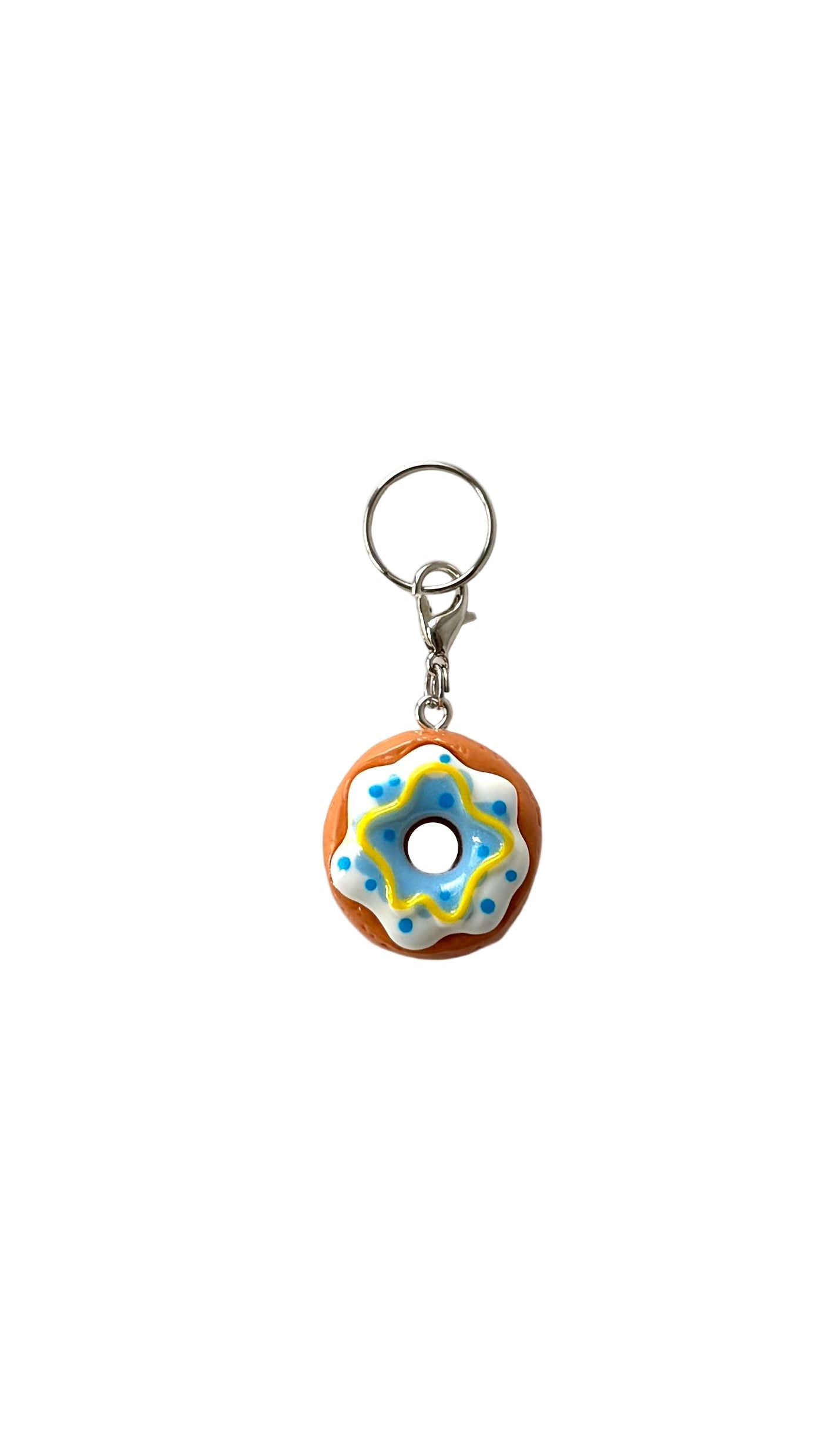 Donut-shaped charm with colorful icing on a white background