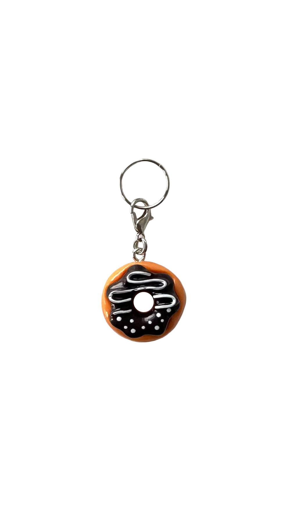 Charm shaped like a doughnut with chocolate filling on a white background
