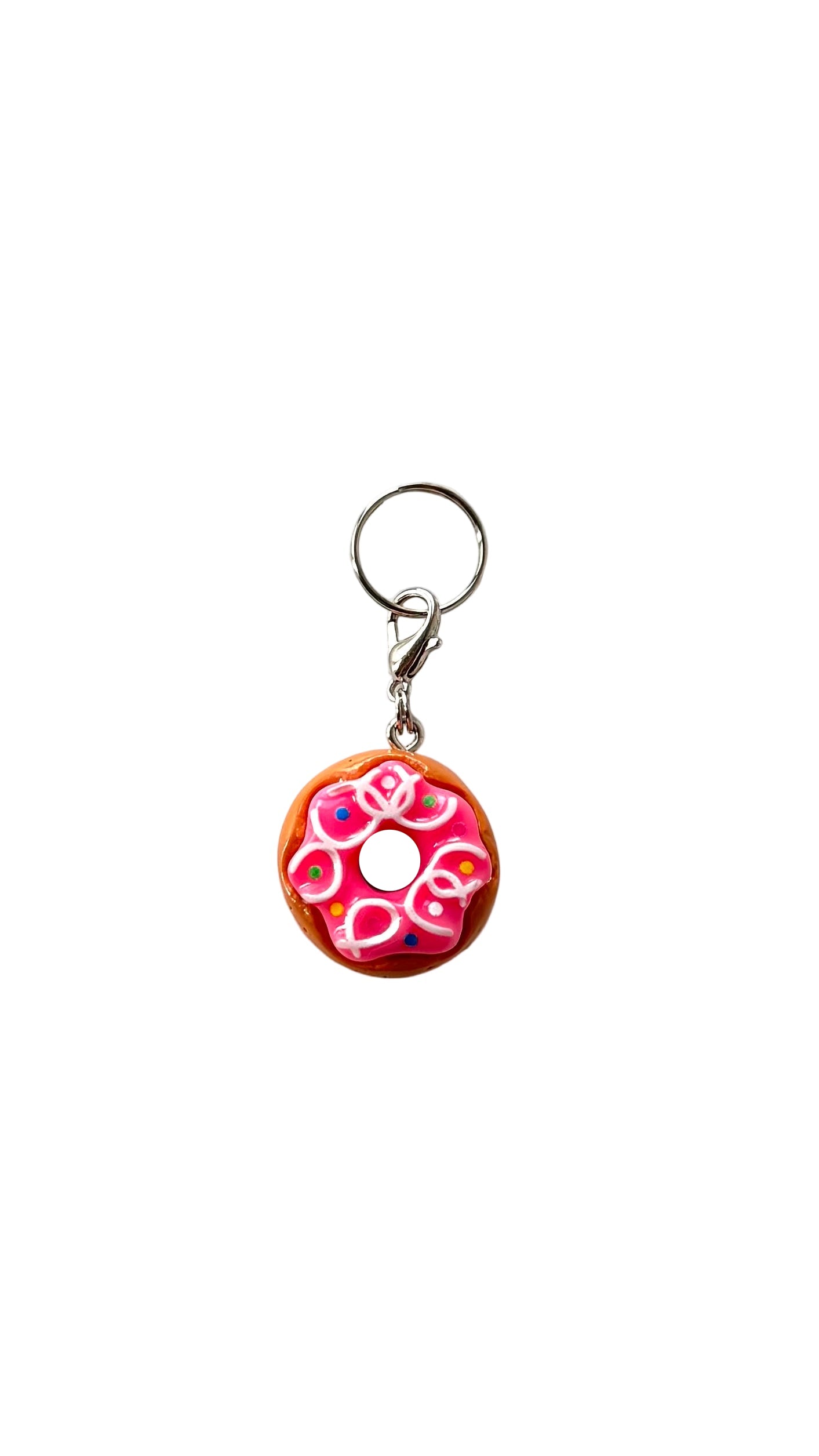 Donut-shaped charm with pink icing and sprinkles on a white background