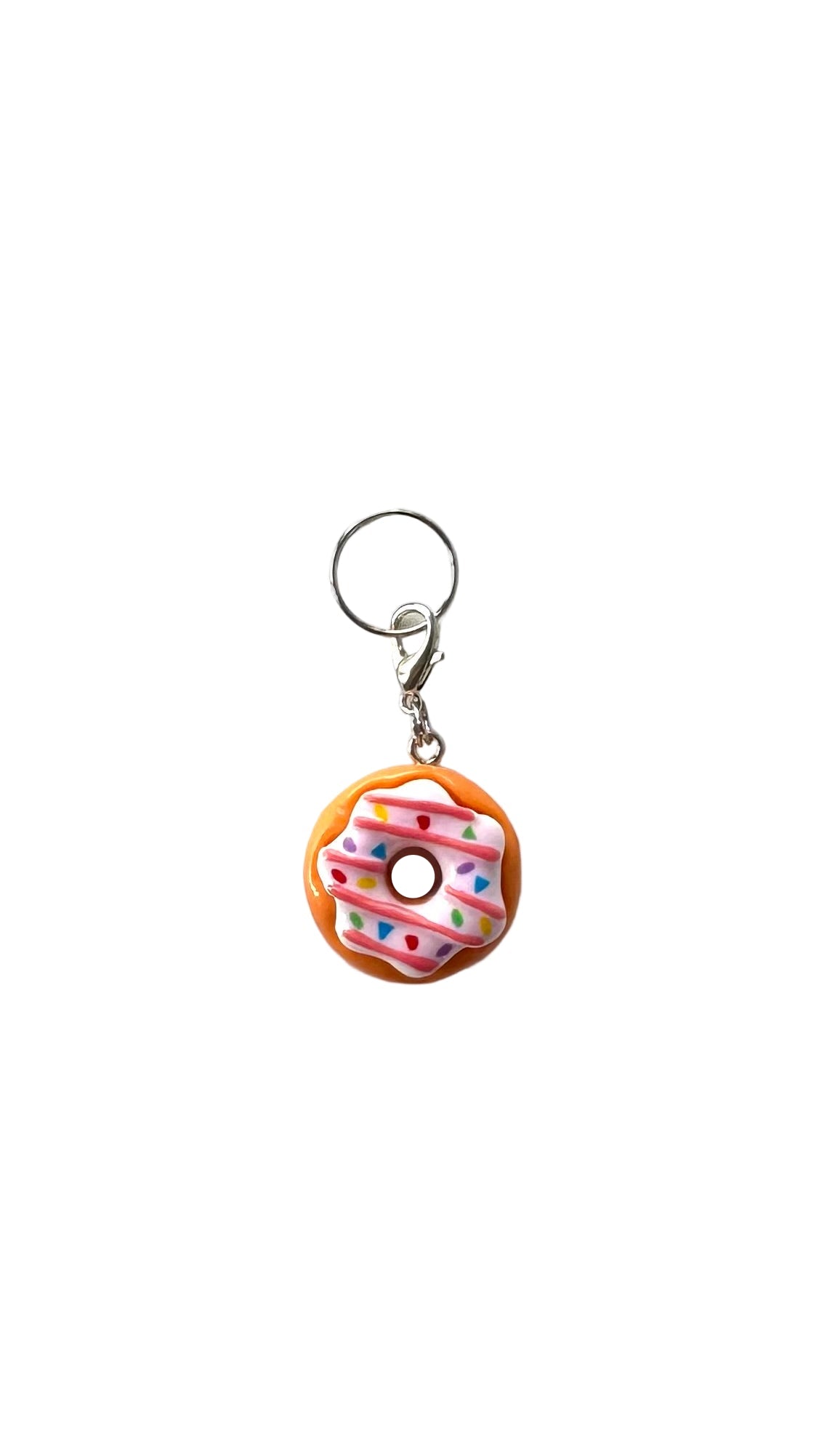 Donut-shaped charm with colorful sprinkles on a white background