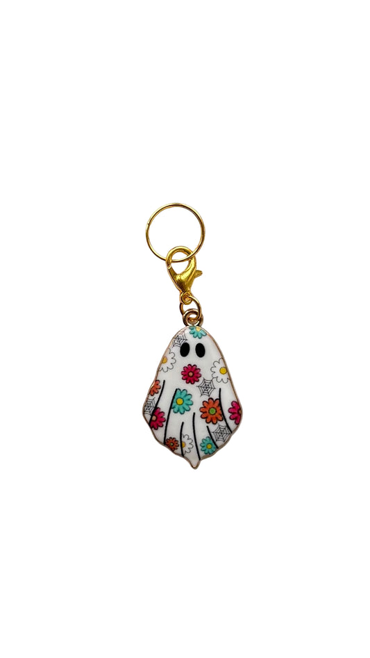 Decorative ghost charm with floral design on a plain background