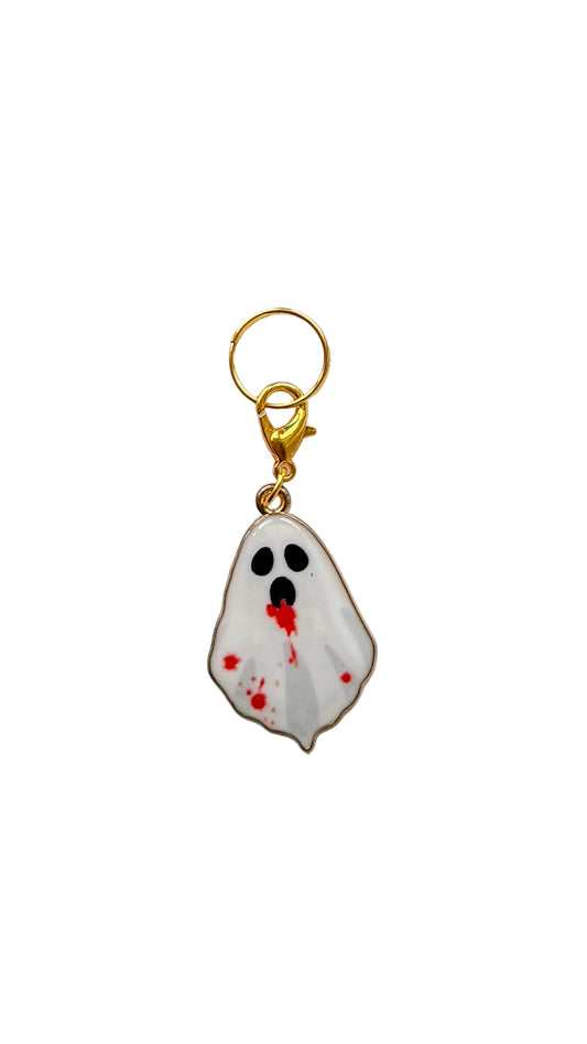 Ghost charm with bloodstains on a white background