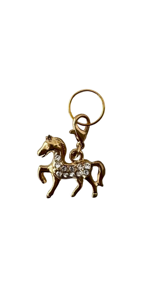Gold horse-shaped charm with rhinestones on a white background