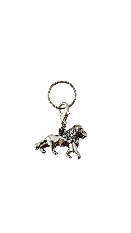 Silver lion charm on a white background