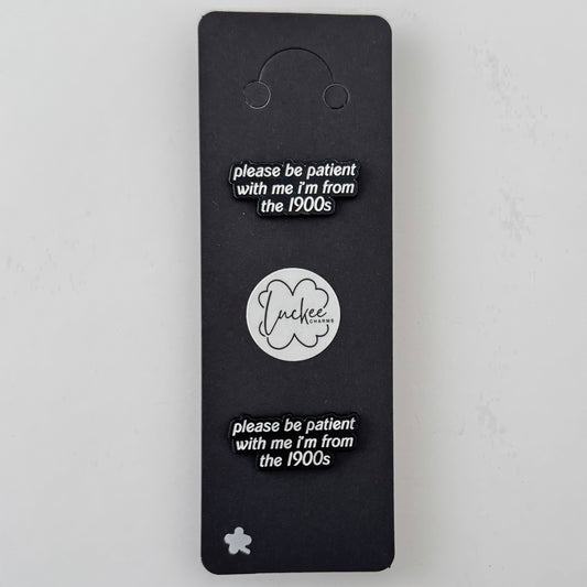 Black card with 'please be patient with me I'm from the 1900s' text and a logo on a white background
