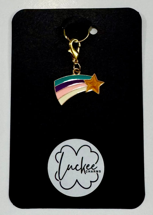Rainbow charm with star on a black card featuring 'Luckee Charms' logo